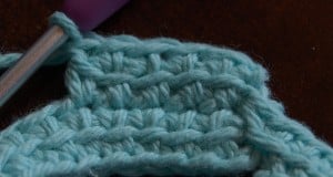 Small crochet swatch of linked double crochet stitches.