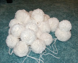 Pile of white yarn poms.