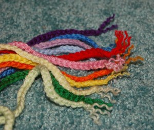 Stack of crochet chain scarves for snowman wreath.