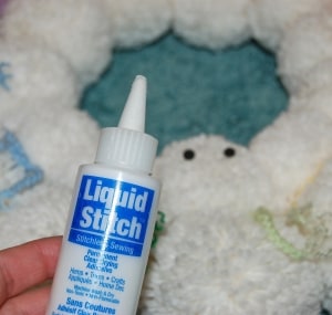 Liquid stitch glue used to attach snowman\'s eyes.