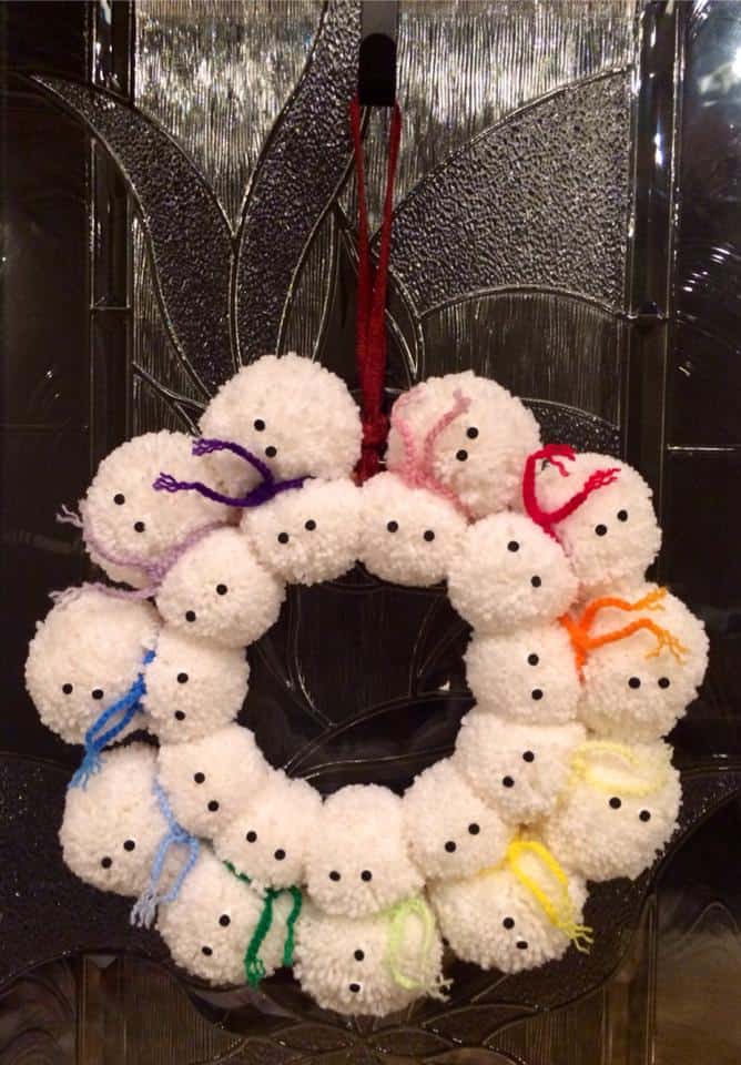 Snowmen crochet pom wreath with chain scarves.