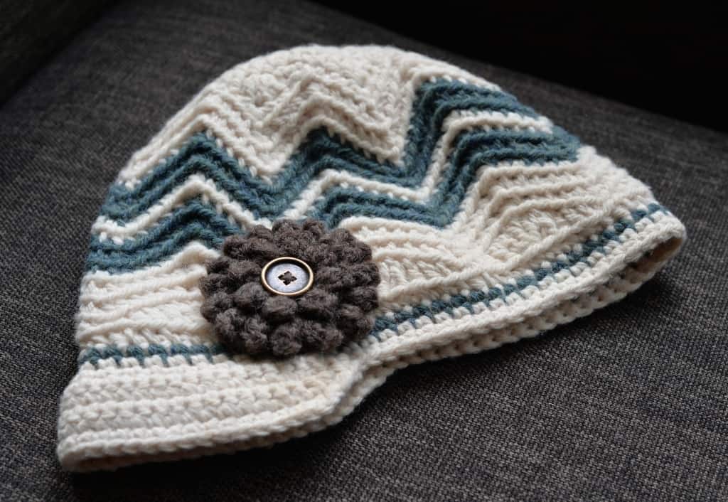 Crochet chevron newsboy hat with brown crochet flower.