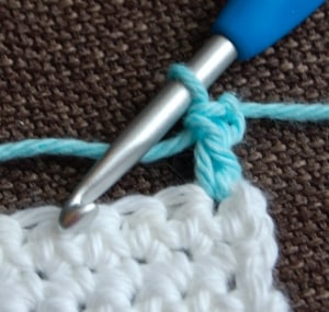 White swatch with blue standing double crochet just made.