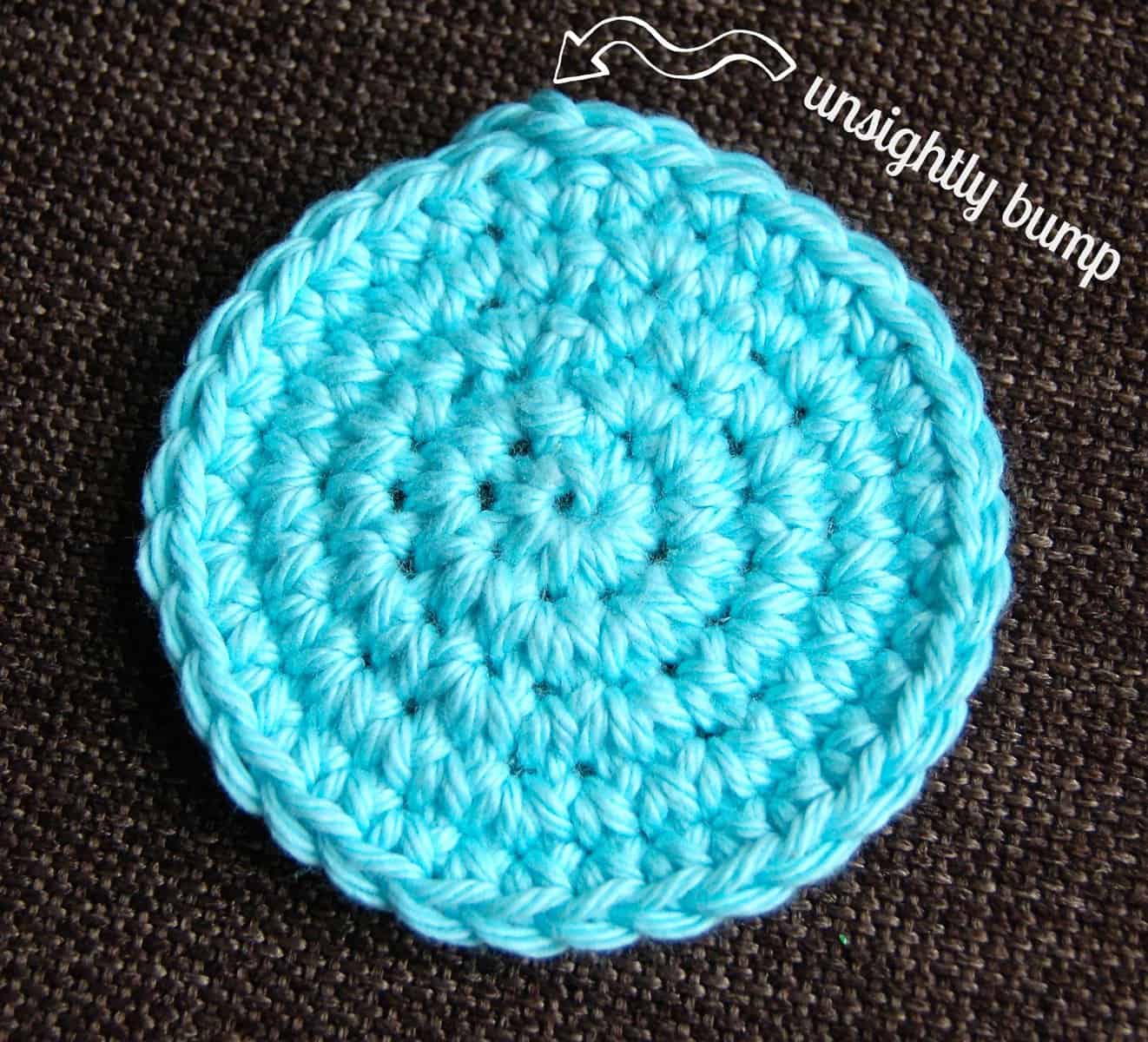 Small aqua crochet circle showing bump created by joining.