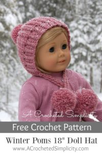 Light pink winter crochet doll hat with yarn poms modeled by blonde 18\" doll.