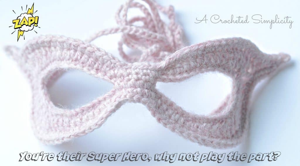 Light pink crochet super hero mask.