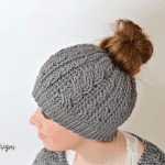 Free Crochet Pattern - Crochet Cabled Messy Bun Hat (Adult Sizes) (video tutorial included) by A Crocheted Simplicity