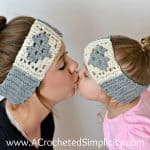 Sisters wearing cream and medium grey crochet ear warmers with hearts in granny stitch.