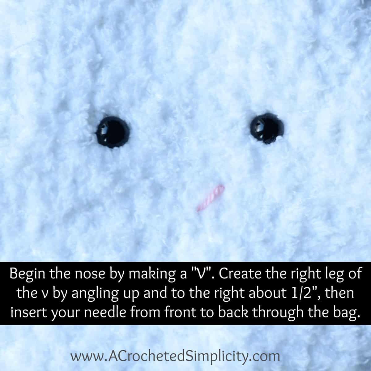 Small pink nose being embroidered on crochet bunny bag.