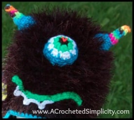 Crochet monster hat with fun fur, big eye and horns.