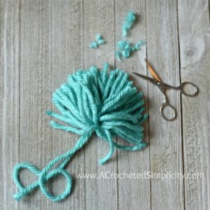 Learn How to Make a Pom Pom - Yarn Pom Tutorial by A Crocheted Simplicity