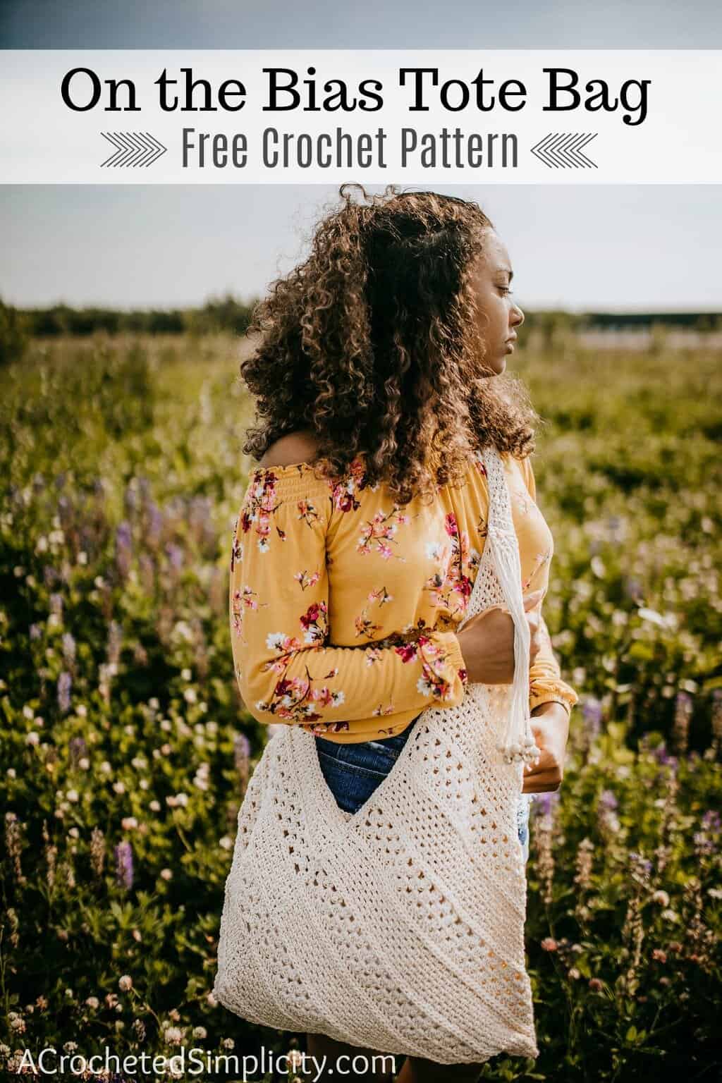 Young girl wearing a crossbody crochet bag with wooden beads on the strap standing in a field of lavender.