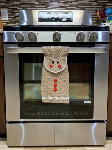 Free Crochet Pattern - Gingerbread Man Kitchen Towel by A Crocheted Simplicity #freecrochetpattern #crochetdishtowel #crochetteatowel #crochetkitchentowel #christmastowel #christmascrochet #gingerbreadman #crochetgingerbreadman