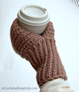 Knit look crochet drink mitt holding a thermal cup of coffee.