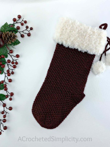 Extended moss stitch crochet Christmas stocking with faux fur cuff.