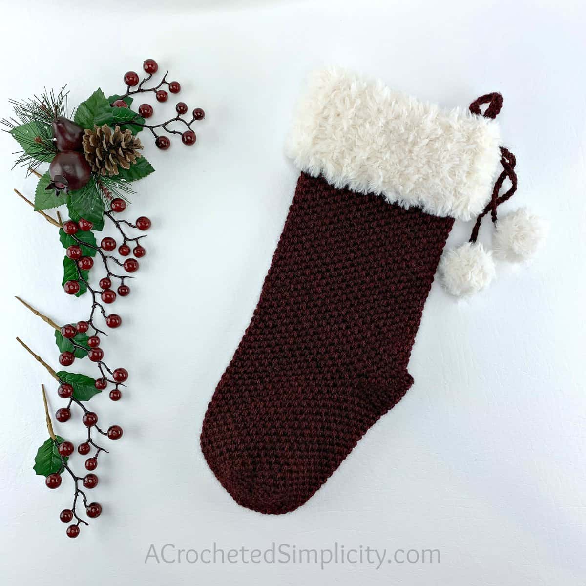 Extended moss stitch crochet Christmas stocking with faux fur cuff.