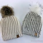 Two knit look crochet short row hats with faux fur poms.