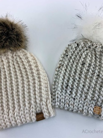 Two knit look crochet short row hats with faux fur poms.