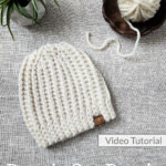 Flat lay of cream knit look crochet beanie.