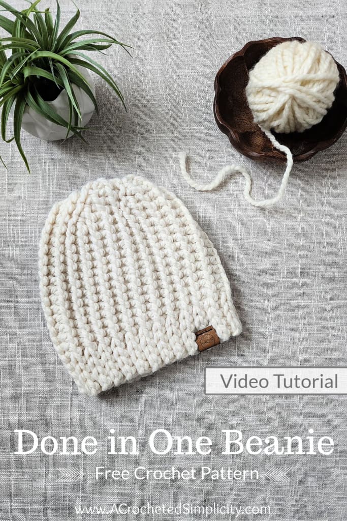 Flat lay of cream knit look crochet beanie.