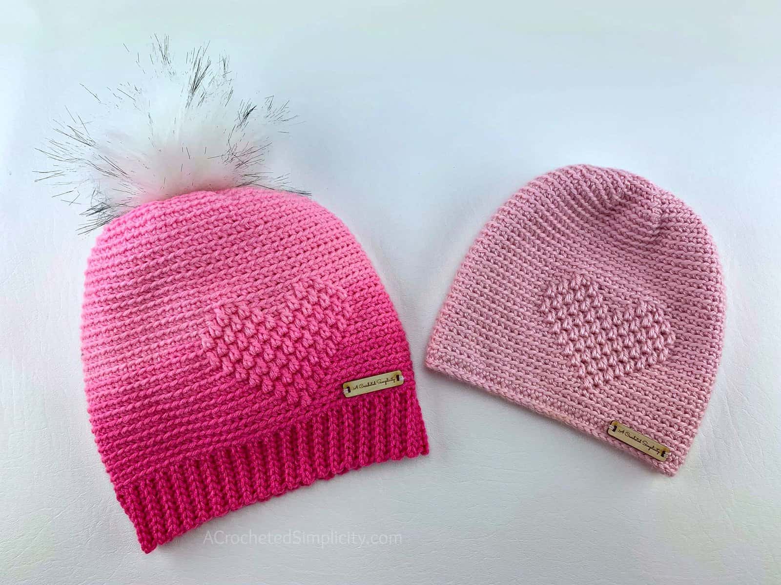 Pink ombre crocheted slouch hat with an embossed heart and light pink embossed crochet heart beanie.