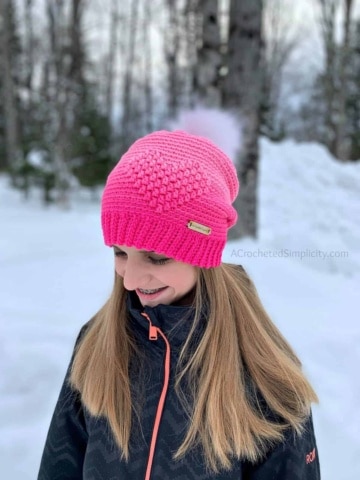 Crochet ombre pink heart slouch hat modeled by young girl.
