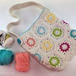 Cream colored hexagon crochet motif tote bag with bright colored accents