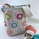 Cream colored crochet motif tote bag with bright colored accents