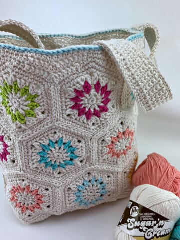 Cream colored crochet motif tote bag with bright colored accents