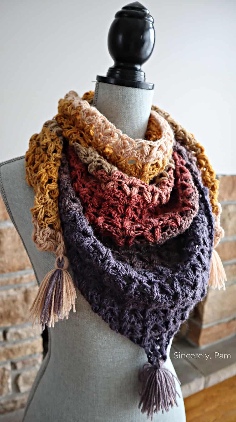 Crochet triangular shawl on sewing mannequin.