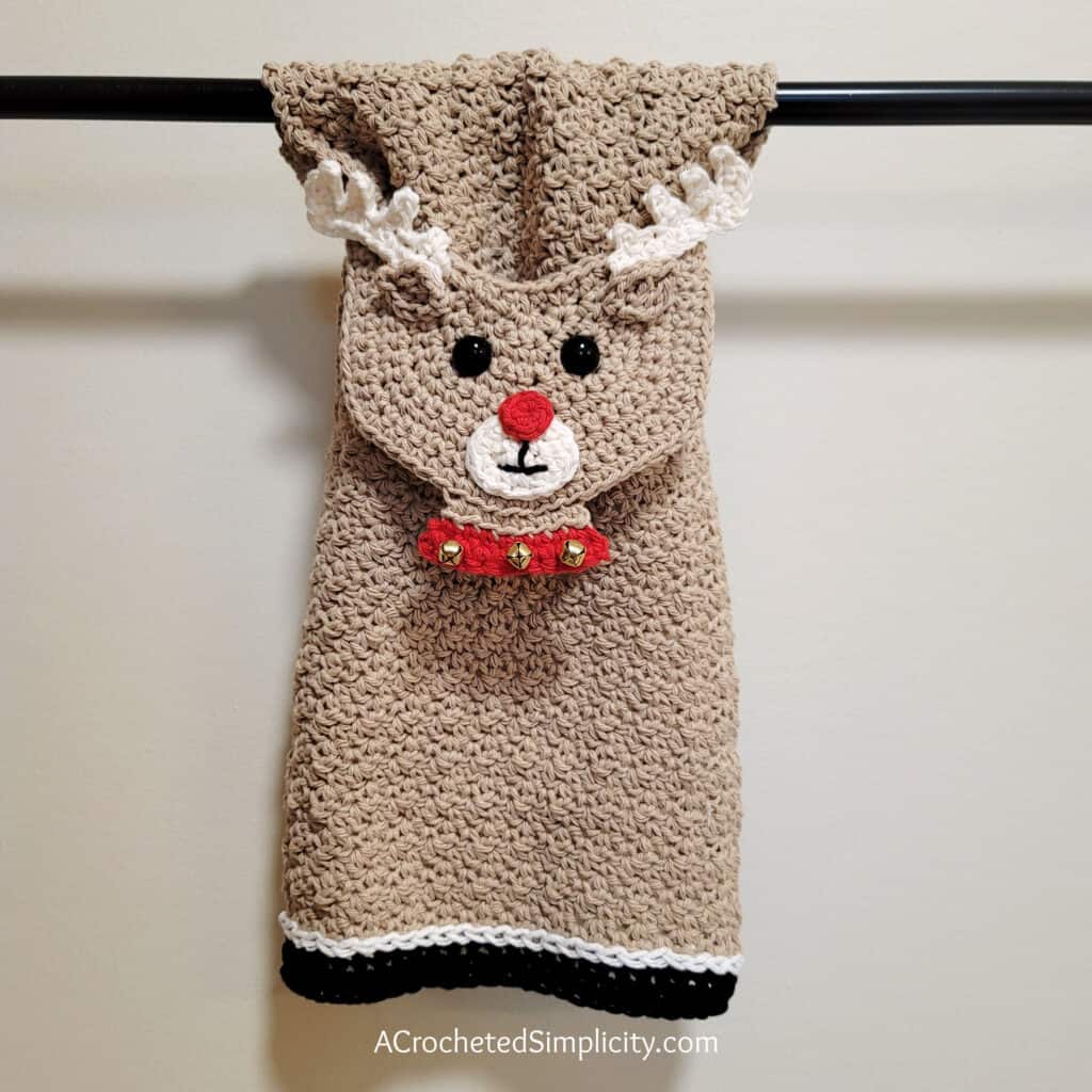 Crochet reindeer kitchen towel hanging on towel bar