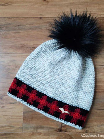 Single crochet beanie with plaid accents and big black faux fur pom.