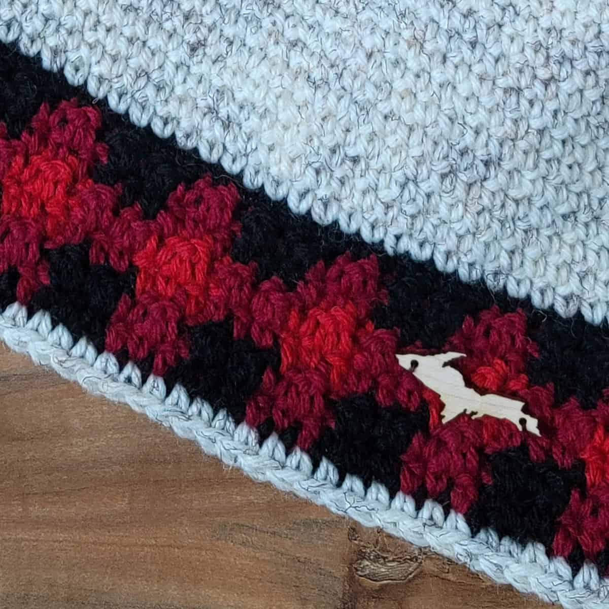 Close-up of crochet plaid accent on brim of hat.