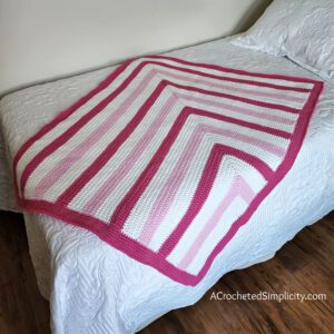 Free Crochet Blanket Pattern - Bubblegum Kisses Baby Blanket by A Crocheted Simplicity #freecrochetpattern #freecrochetblanketpattern #crochetlapghanpattern #crochetblanketpattern #crochet #crochetlapghan #crochetafghan #crochetpuffstitch #homemadeafghan #crochettexture #crochetbabyblanket #crochetblanketpattern #babyblanketpattern #freebabyblanket