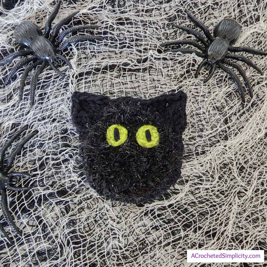 Free Crochet Pattern - Black Cat Dish Scrubby by A Crocheted Simplicity #freecrochetpattern #crochetscrubby #crochetscrubbypattern #crochetdishscrubby #halloweencrochet #crochetblackcat #blackcat #crochetkitchen #crochet #handmade #halloweencrochet