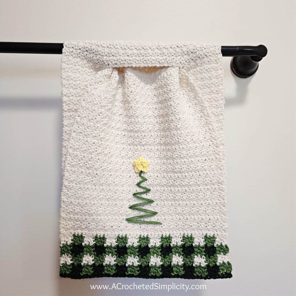 Christmas tree crochet kitchen towel hanging towel with keyhole, christmas tree, and plaid hangin on towel bar