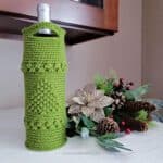 Free Crochet Wine Tote Pattern - O' Christmas Tree Wine Tote by A Crocheted Simplicity. #crochetchristmas #handmadechristmas #crochetwinetote #crochetwinecozy #winetote #winecozy #christmaswinetote #crochetchristmaswinetote #crochetchristmastree #freecrochetpattern #winetotepattern #crochetwinetotepattern #lastminutecrochetgifts