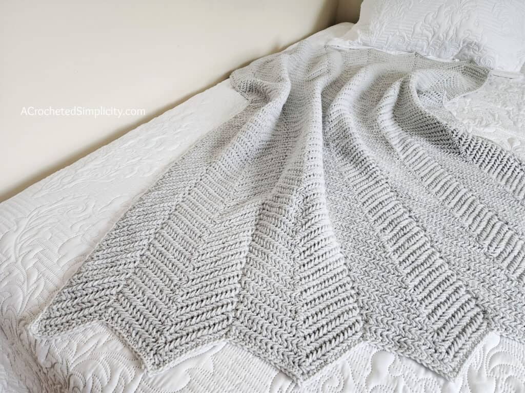 Herringbone Single Crochet Ripple Stitch Blanket - Free Herringbone Crochet Blanket Pattern by A Crocheted Simplicity #crochetherringbonestitch #herringbonesinglecrochet #herringbonecrochetblanket #freecrochetblanketpattern #crochetrippleblanket #crochetchevronblanket #crochetrippleafghan #crochetripplestitch #freecrochetblanketpattern #herringbonesinglecrochetrippleblanket #handmadeblanket #crochetlapghan