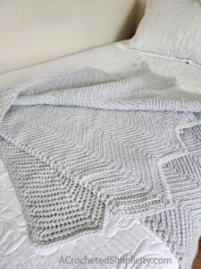 Herringbone Single Crochet Ripple Stitch Blanket - Free Herringbone Crochet Blanket Pattern by A Crocheted Simplicity #crochetherringbonestitch #herringbonesinglecrochet #herringbonecrochetblanket #freecrochetblanketpattern #crochetrippleblanket #crochetchevronblanket #crochetrippleafghan #crochetripplestitch #freecrochetblanketpattern #herringbonesinglecrochetrippleblanket #handmadeblanket #crochetlapghan