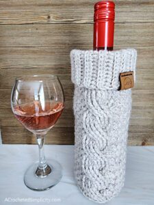 Twisted Textures Wine Cozy - Free Crochet Pattern by A Crocheted Simplicity #freecrochetpattern #crochetwinecozy #crochetwinetote #crochetcables #crochetminibeanstitch #minibeanstitch #handmadewinecozy #quickcrochetgift #oneskeincrochet #diywinecozy