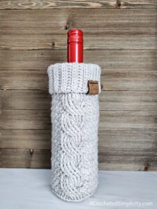 Twisted Textures Wine Cozy - Free Crochet Pattern by A Crocheted Simplicity #freecrochetpattern #crochetwinecozy #crochetwinetote #crochetcables #crochetminibeanstitch #minibeanstitch #handmadewinecozy #quickcrochetgift #oneskeincrochet #diywinecozy