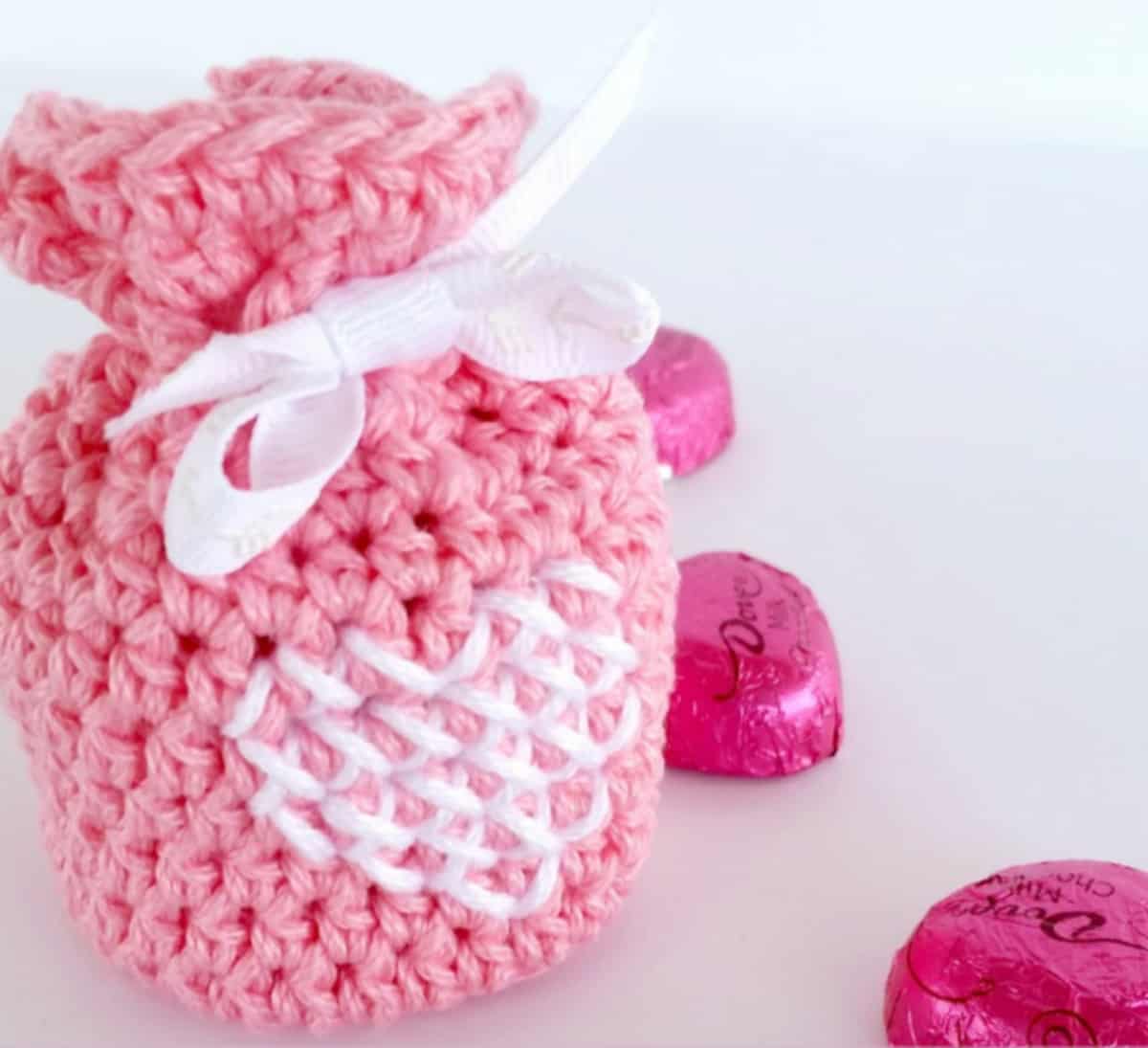 Pink crochet candy bag with cross stitch heart.