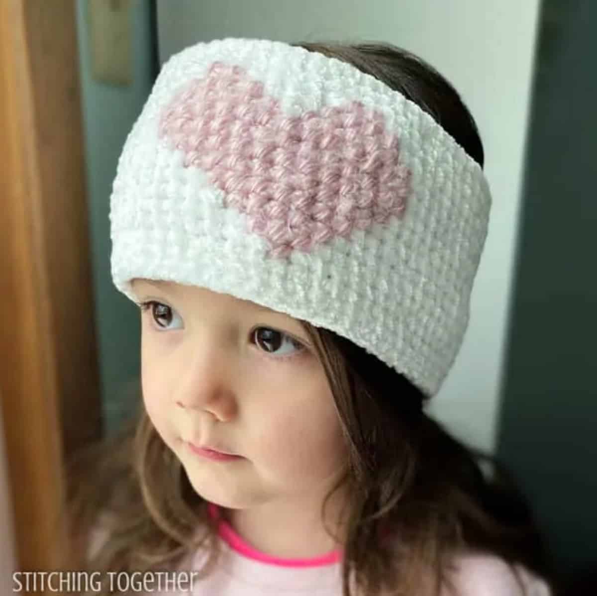 Crochet head warmer with large pink heart.