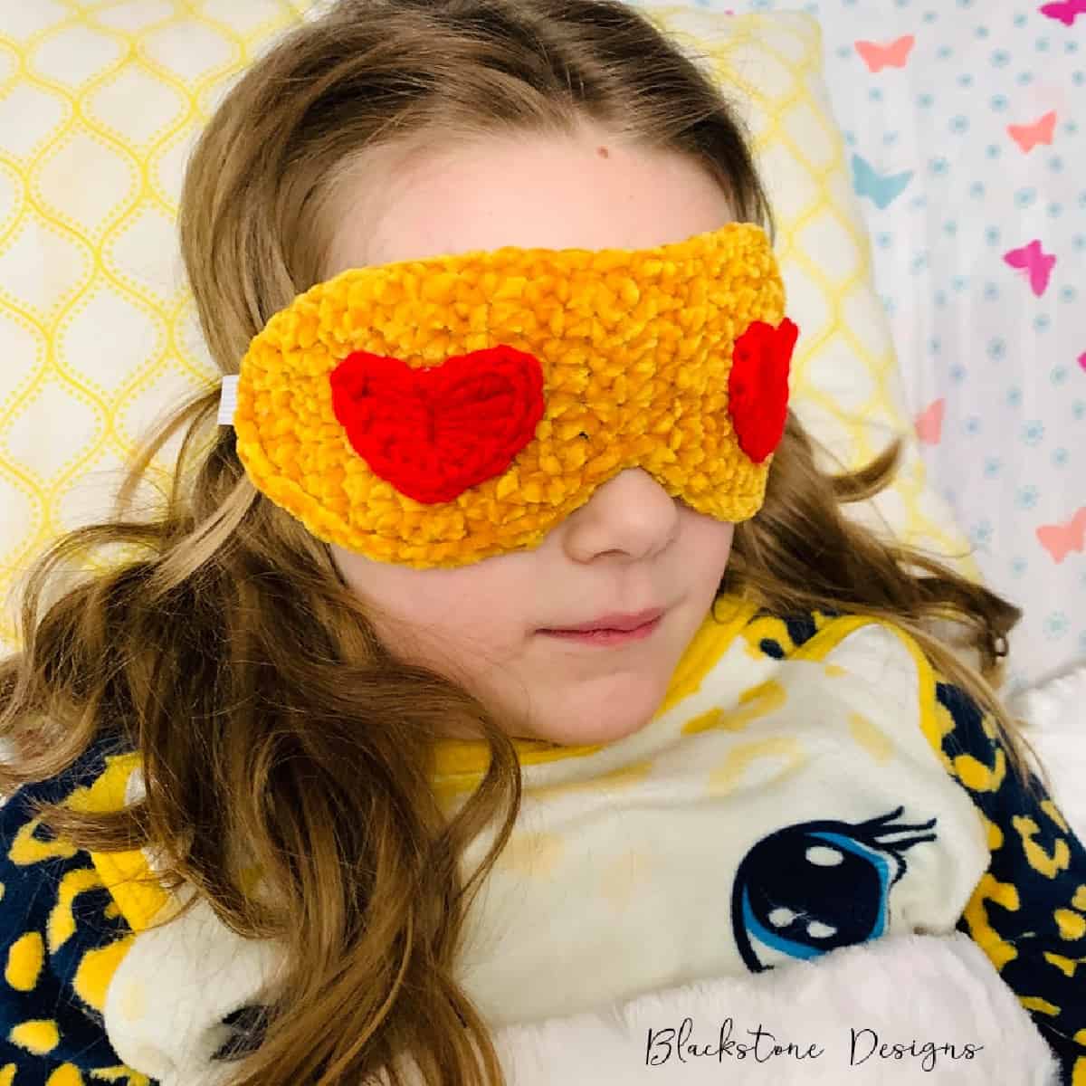 Crochet heart emoji sleep mask.