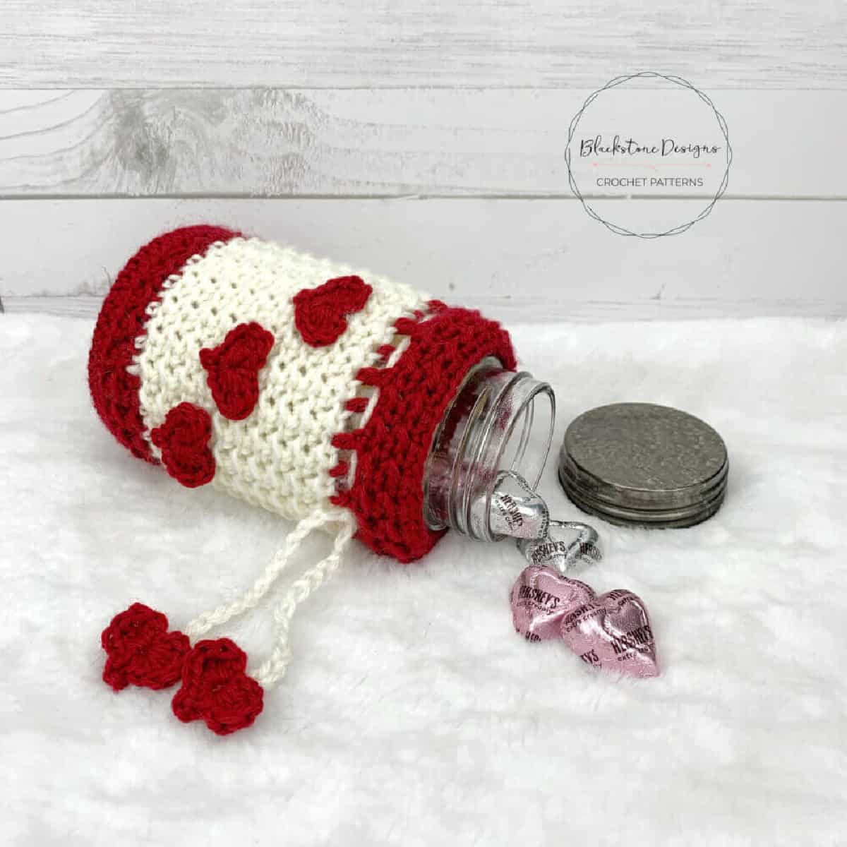 Crochet Valentine's Jar Cozy with red crochet hearts.