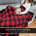 Young girl sitting with small yorkie on couch covered with buffalo plaid crochet blanket.