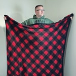 This image is of my husband proudly showing off his new C2C Crochet Buffalo Plaid Blanket!