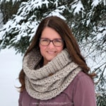 Close up of woman outside wearing chunky crochet hooded cowl.