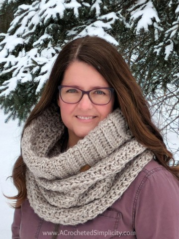 Close up of woman outside wearing chunky crochet hooded cowl.