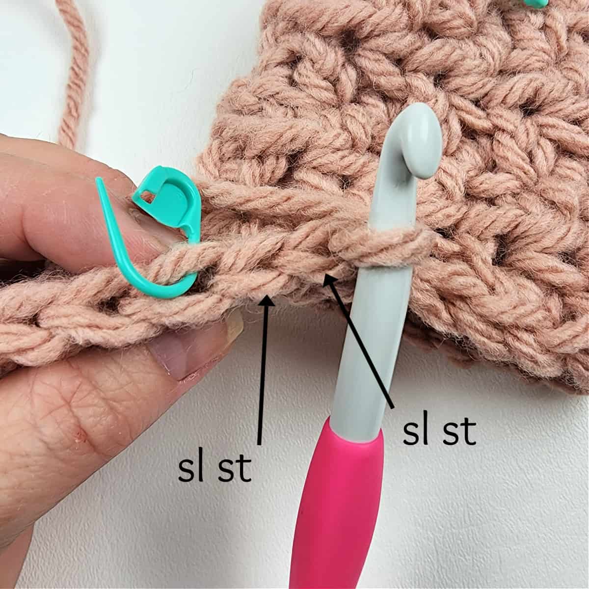 After turning to work the rest of Row 2, you can see the 2 sl sts you worked before turning, and the stitch marked where you will work the first hdc.